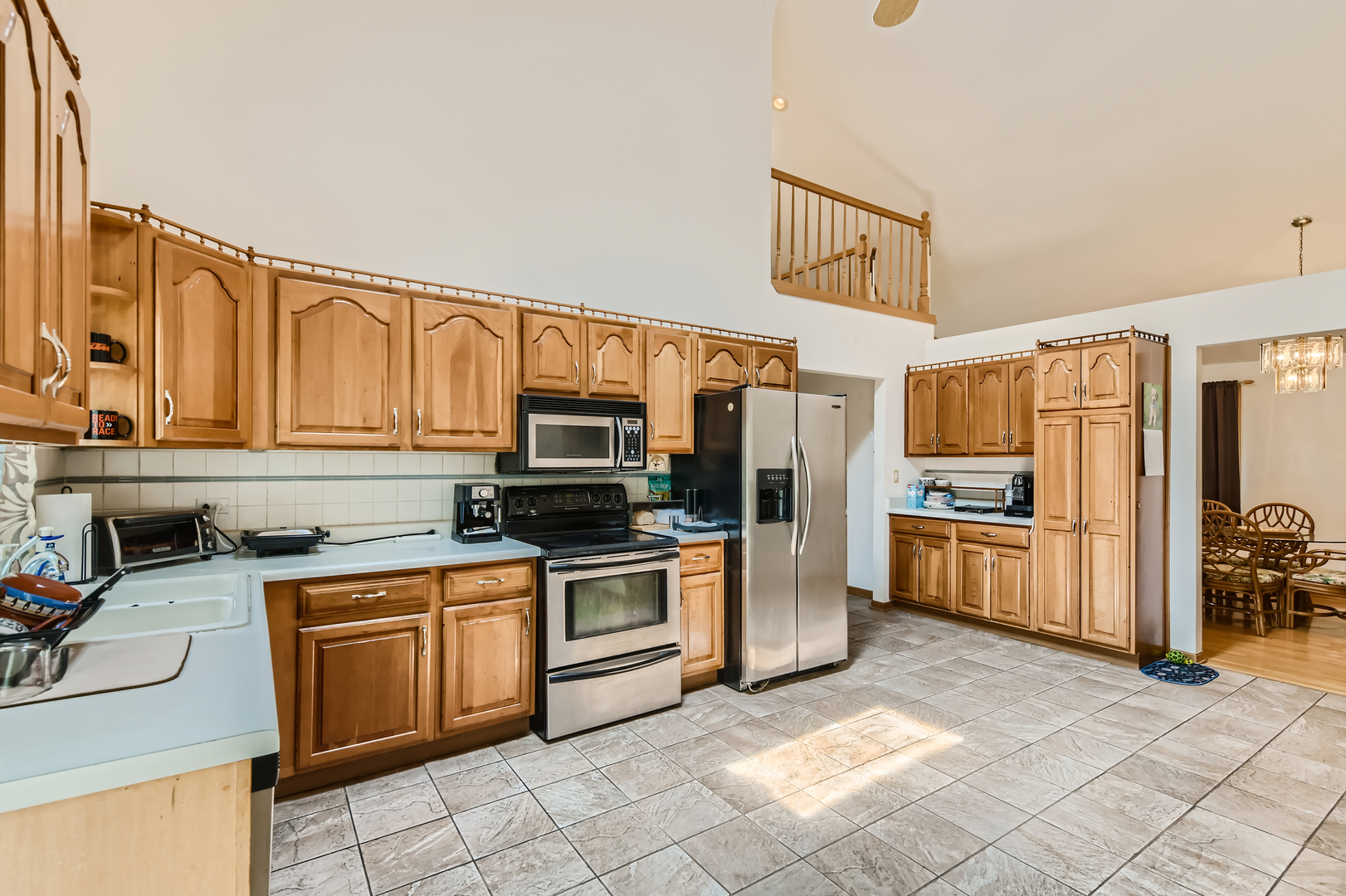 4057 Custer Avenue Lyons, IL 60534 - Photo 10 of 28 a kitchen with stainless steel appliances granite countertop a stove top oven a sink dishwasher and a refrigerator with cabinets