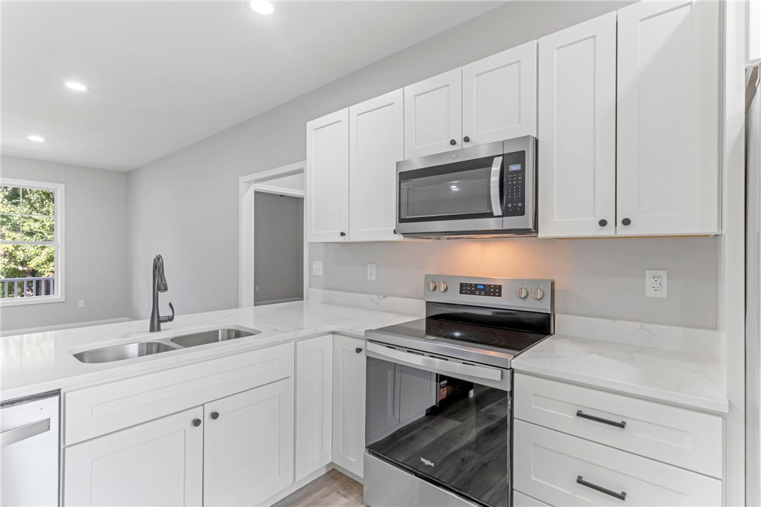 1115 Marshall Road Anderson, SC 29626 - Photo 16 of 35 Crisp white cabinetry paired with sleek solid surface countertops defines this modern culinary space.