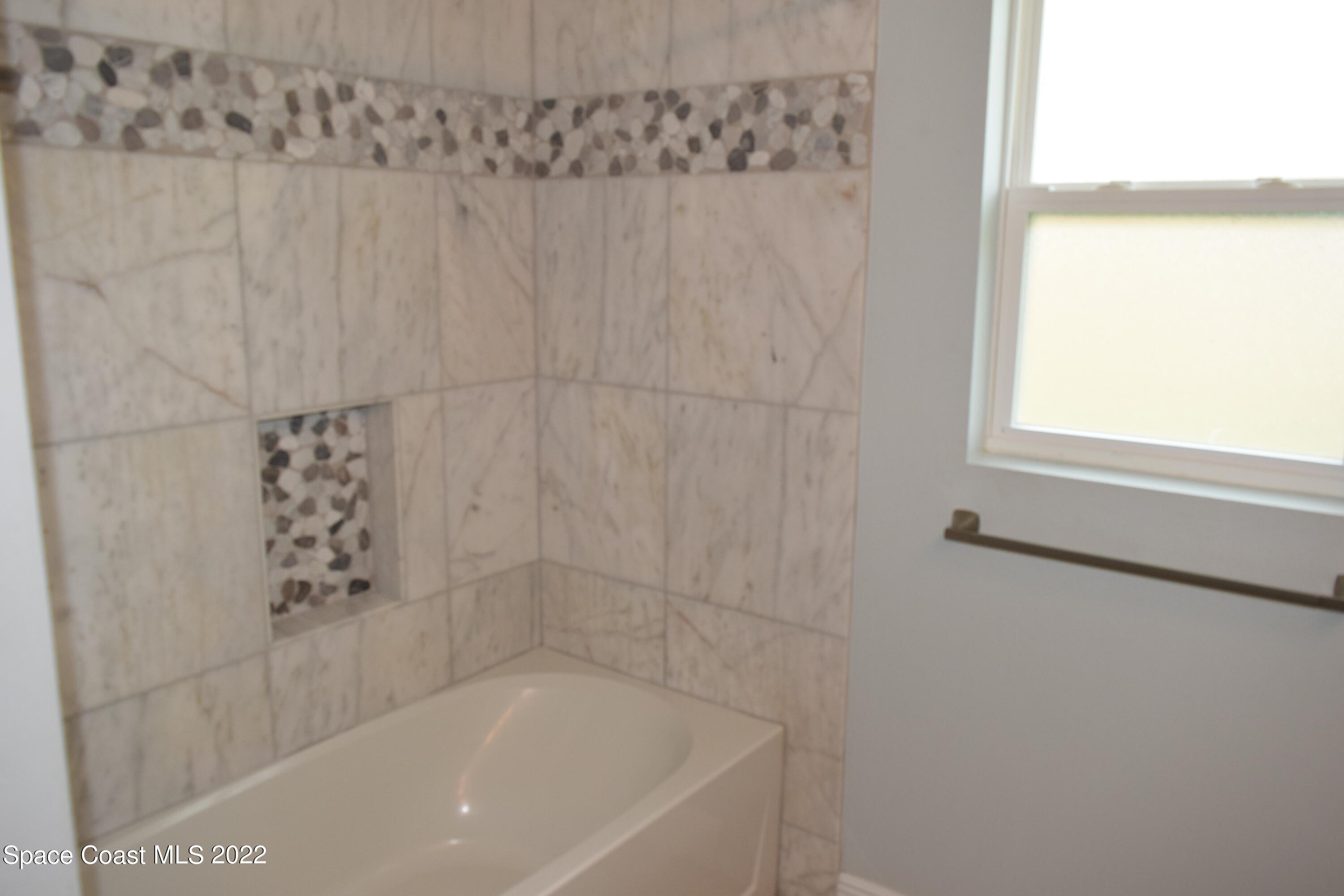 1328 Hazel Street Northwest Palm Bay, FL 32907 - Photo 17 of 28 a close view of a bathtub in bathroom