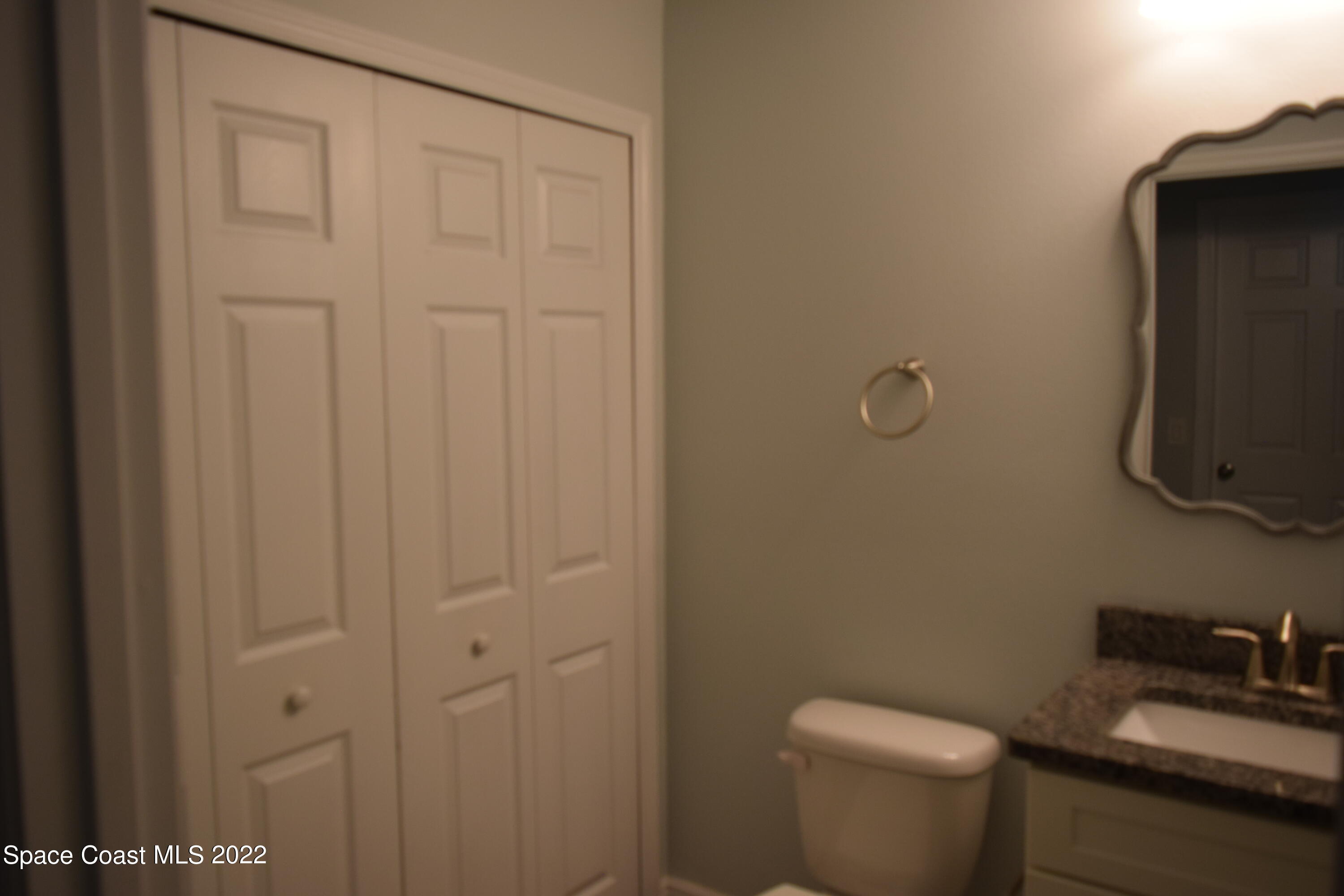 1328 Hazel Street Northwest Palm Bay, FL 32907 - Photo 21 of 28 a bathroom with a toilet