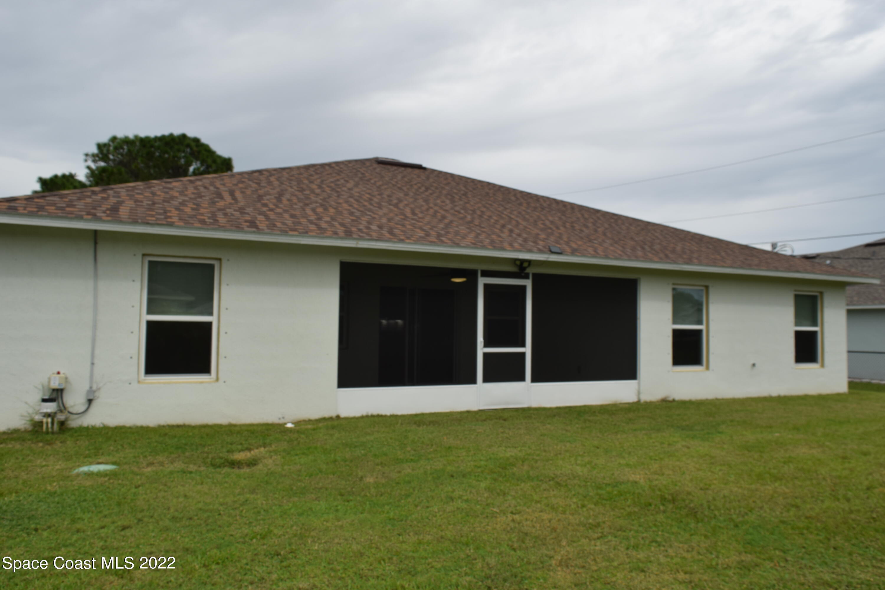 1328 Hazel Street Northwest Palm Bay, FL 32907 - Photo 25 of 28 a house with garden in front of it