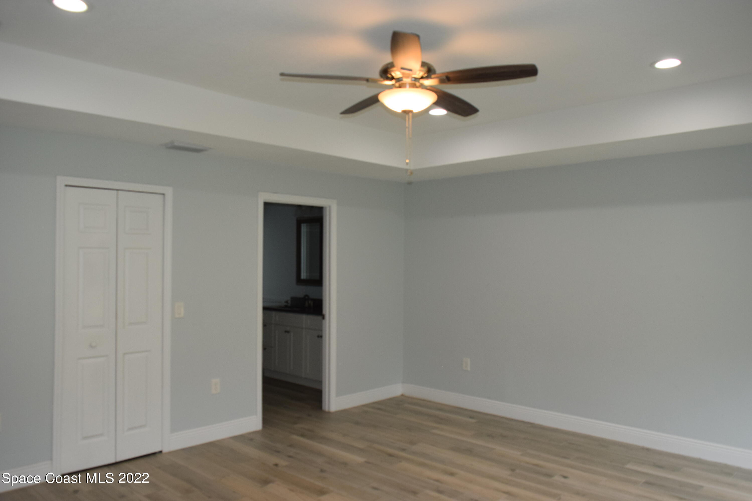 1328 Hazel Street Northwest Palm Bay, FL 32907 - Photo 8 of 28 a view of an empty room with wooden floor
