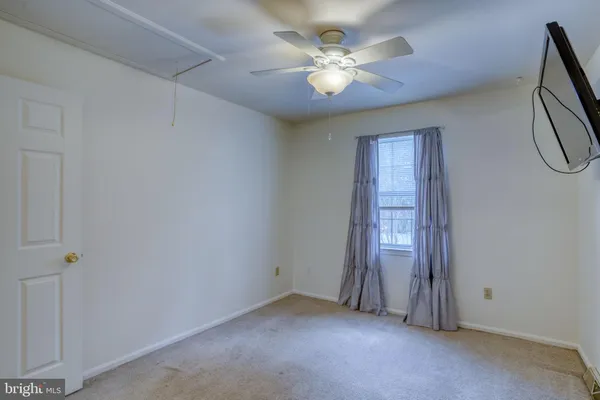 a view of a livingroom with a chandelier fan