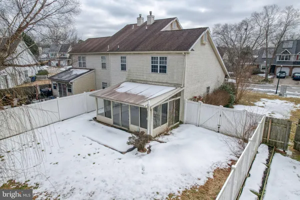 a view of a house with wooden fence
