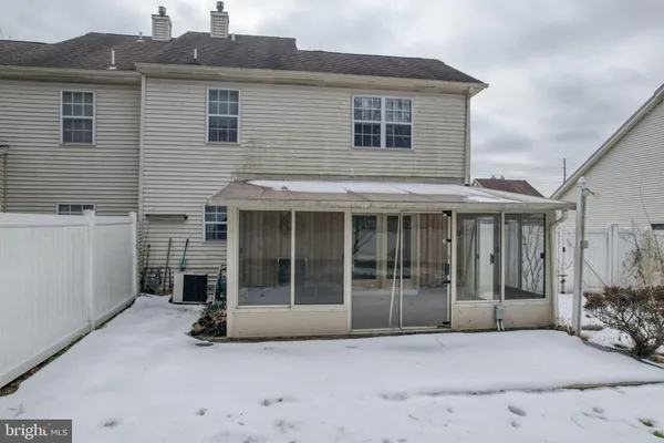 a view of a house with a large window and a large parking space