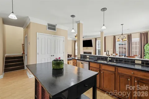 a kitchen with a sink a counter top space and stainless steel appliances