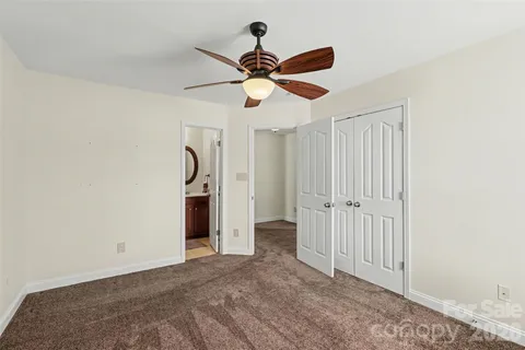 a view of empty room with ceiling fan