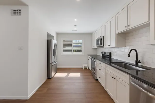 a view of a kitchen with a sink and dishwasher