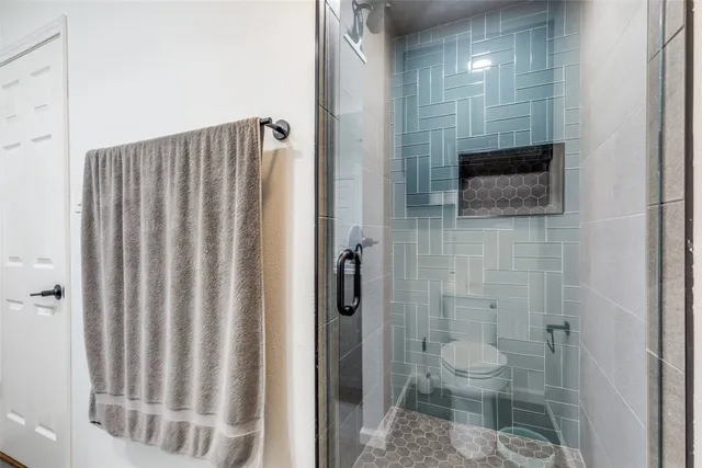 a bathroom with a toilet a sink and shower