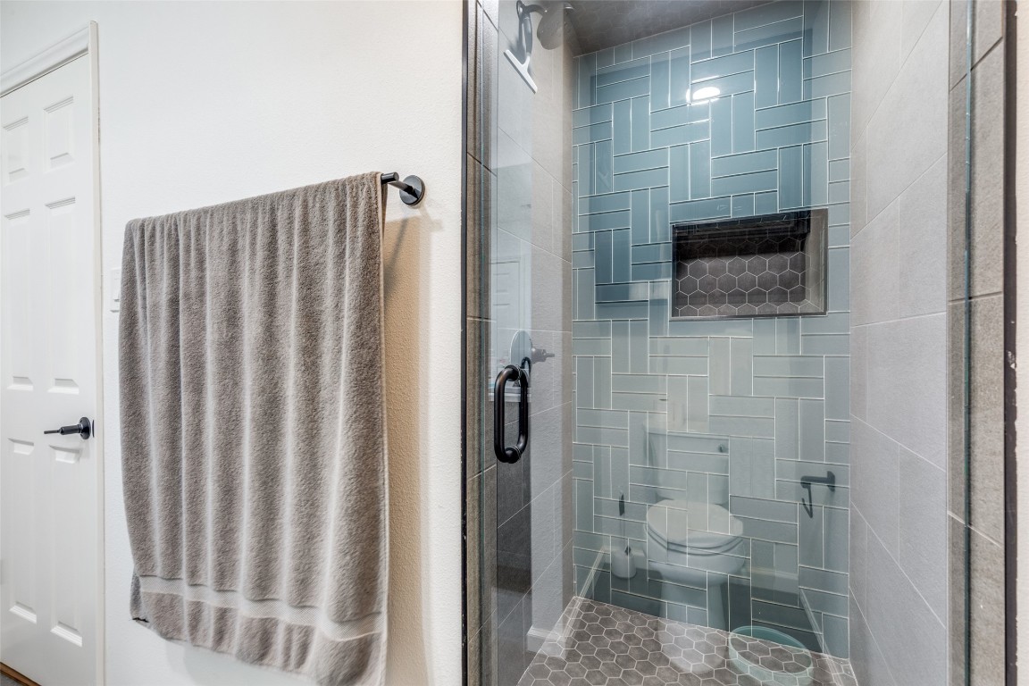 11127 Pinehurst Drive, Unit C Austin, TX 78747 - Photo 18 of 25 a bathroom with a toilet a sink and shower