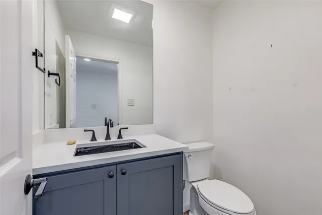 a bathroom with a sink toilet and vanity
