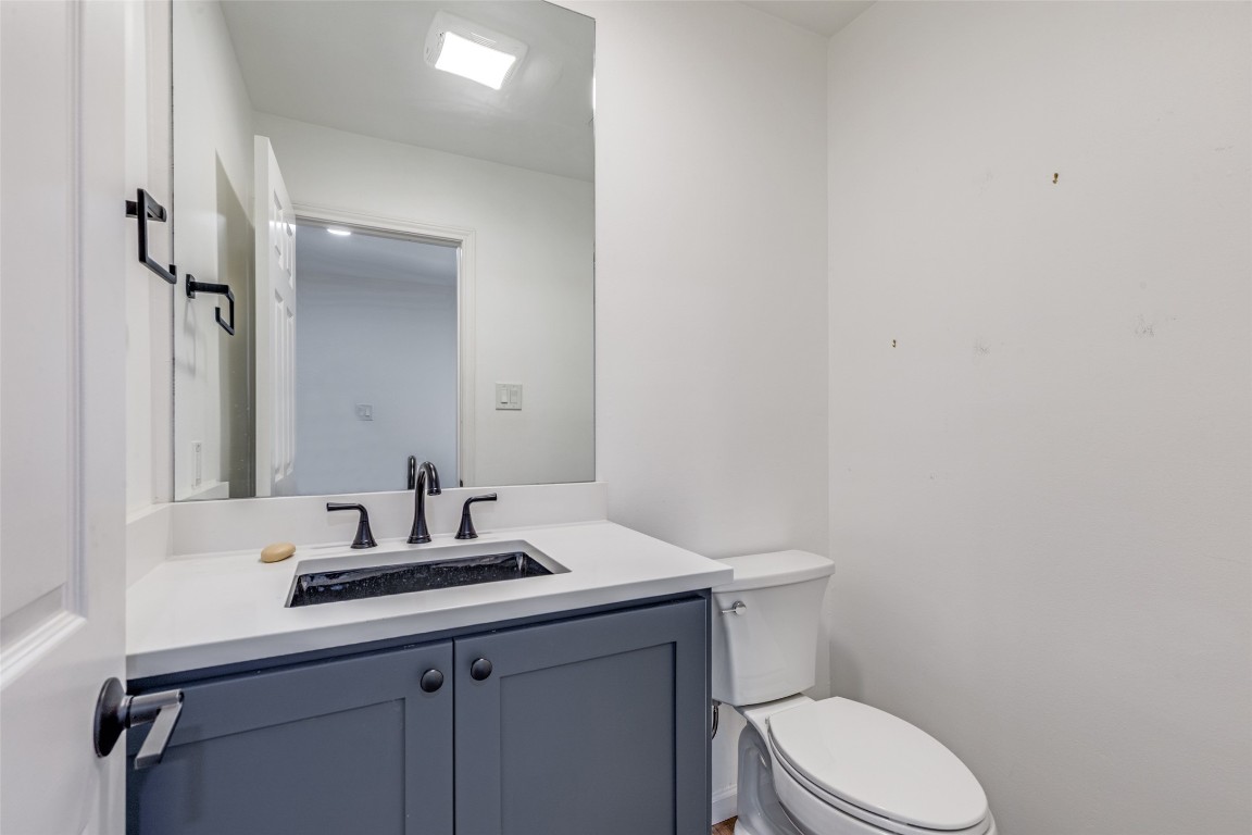 11127 Pinehurst Drive, Unit C Austin, TX 78747 - Photo 20 of 25 a bathroom with a sink toilet and vanity