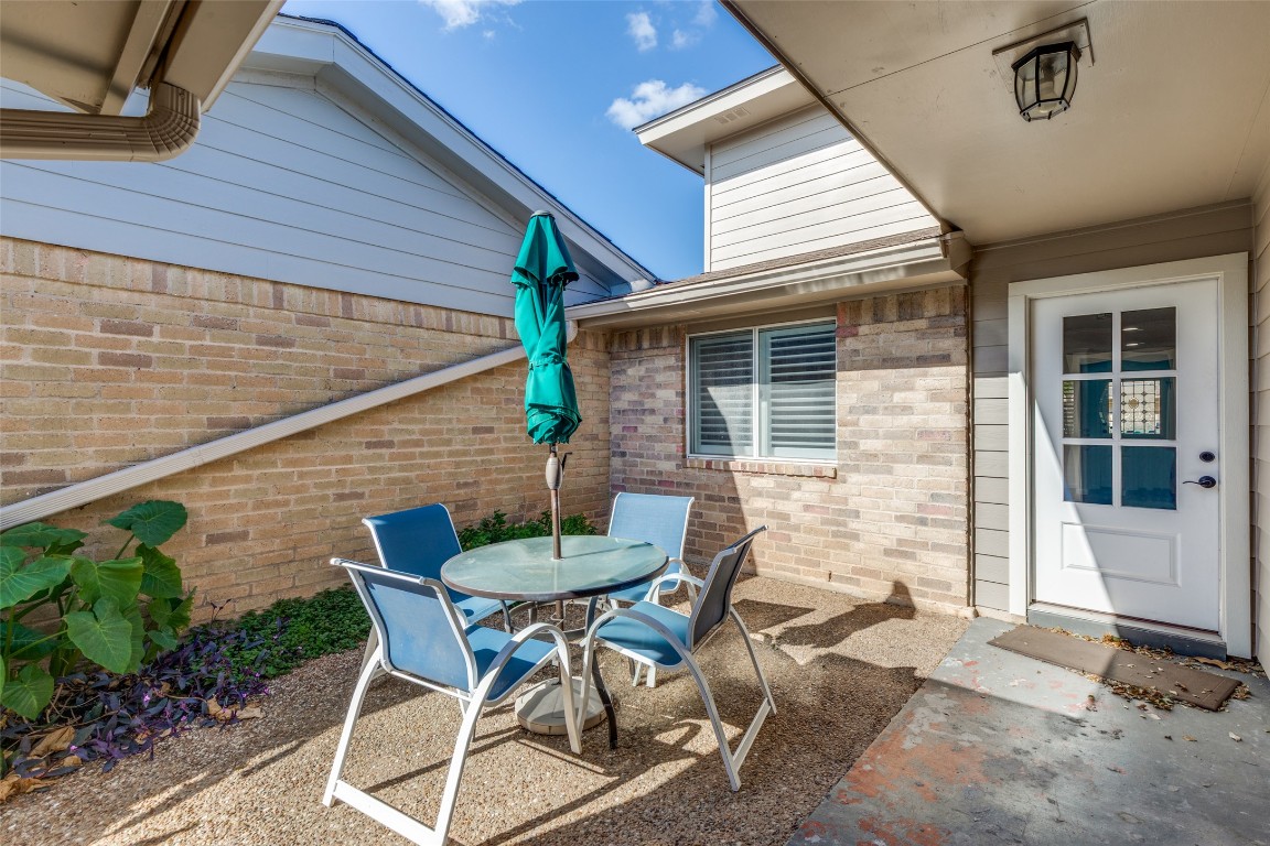 11127 Pinehurst Drive, Unit C Austin, TX 78747 - Photo 24 of 25 a patio with table and chairs and potted plants
