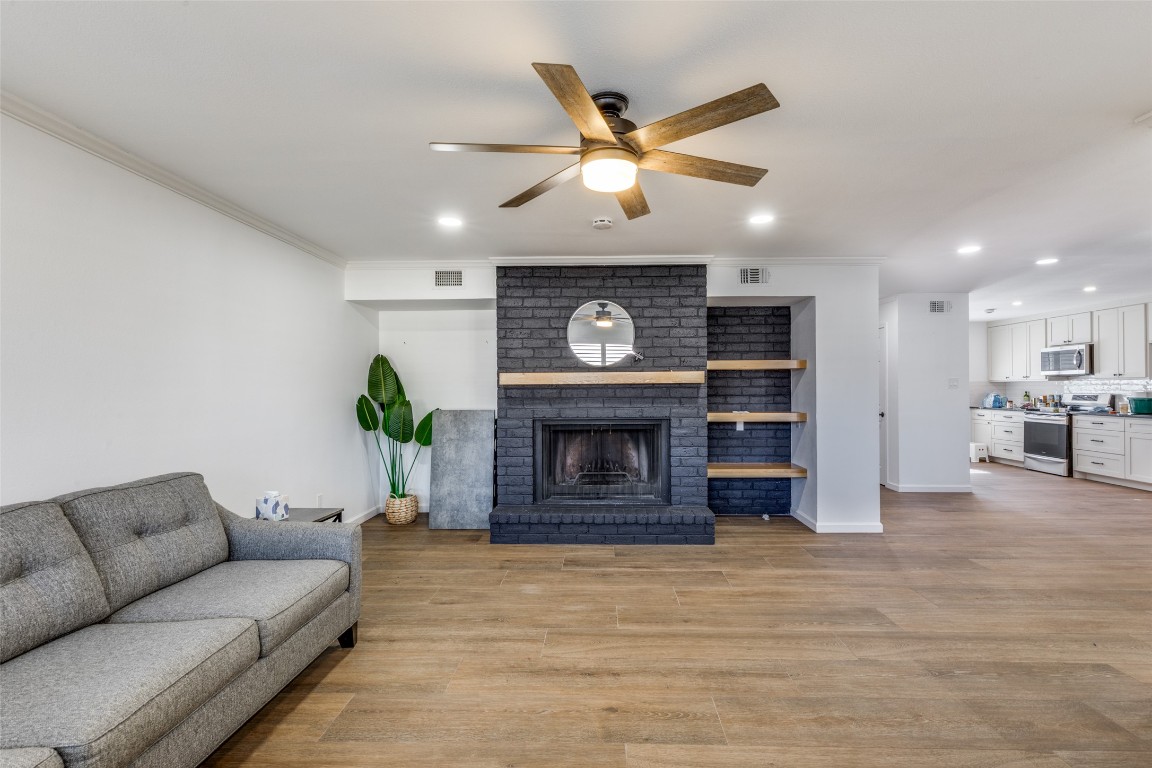 11127 Pinehurst Drive, Unit C Austin, TX 78747 - Photo 4 of 25 a living room with furniture and a fireplace