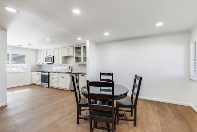 a view of a dining room with furniture and wooden floor