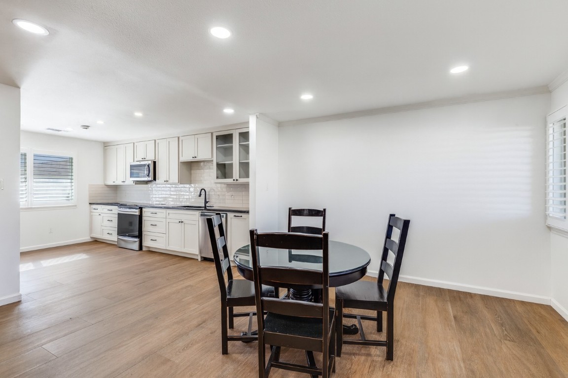 11127 Pinehurst Drive, Unit C Austin, TX 78747 - Photo 9 of 25 a view of a dining room with furniture and wooden floor