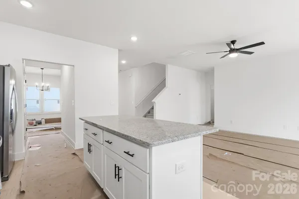 a bathroom with a granite countertop sink and white cabinets