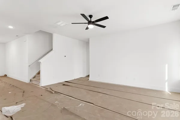 a view of a livingroom with a ceiling fan and window