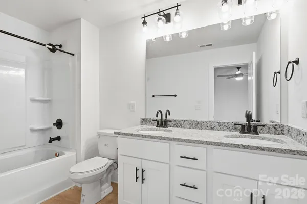 a bathroom with a toilet and a bathtub