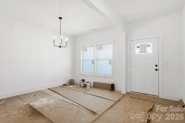 a room with a chandelier and a window