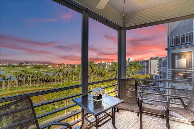 a view of a city from a balcony with furniture