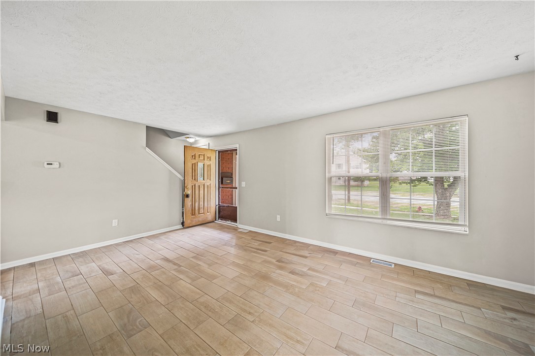 9576 Cloverleaf Road Windham, OH 44288 - Photo 6 of 29 Spare room with a textured ceiling and light wood-type flooring