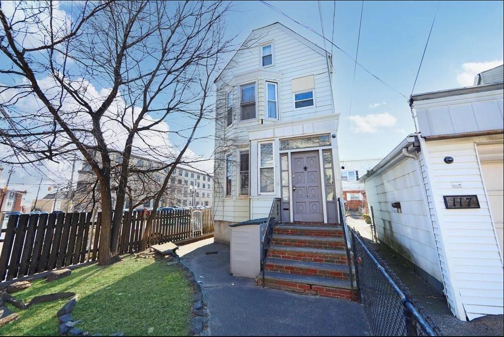 117 Hackensack Plank Road Weehawken, NJ 07086 - Photo 11 of 18 a front view of a house with a garden and plants