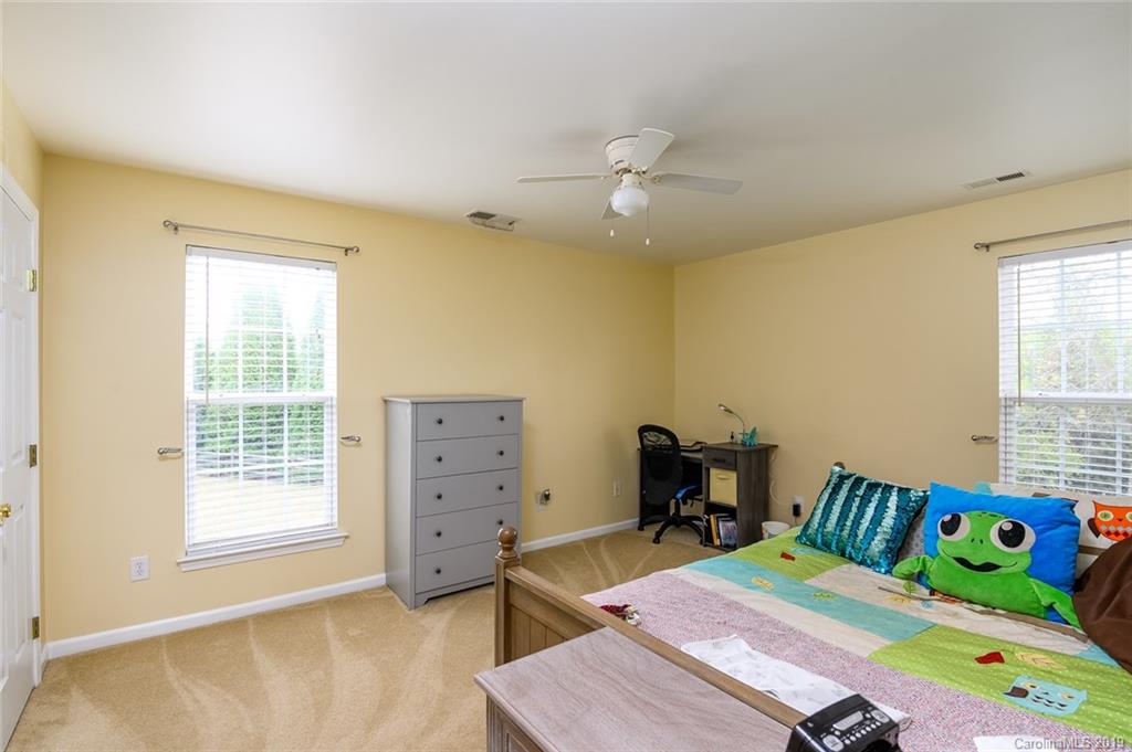 635 Eaton Court Fort Mill, SC 29708 - Photo 19 of 28 a bedroom with a bed and a table in it