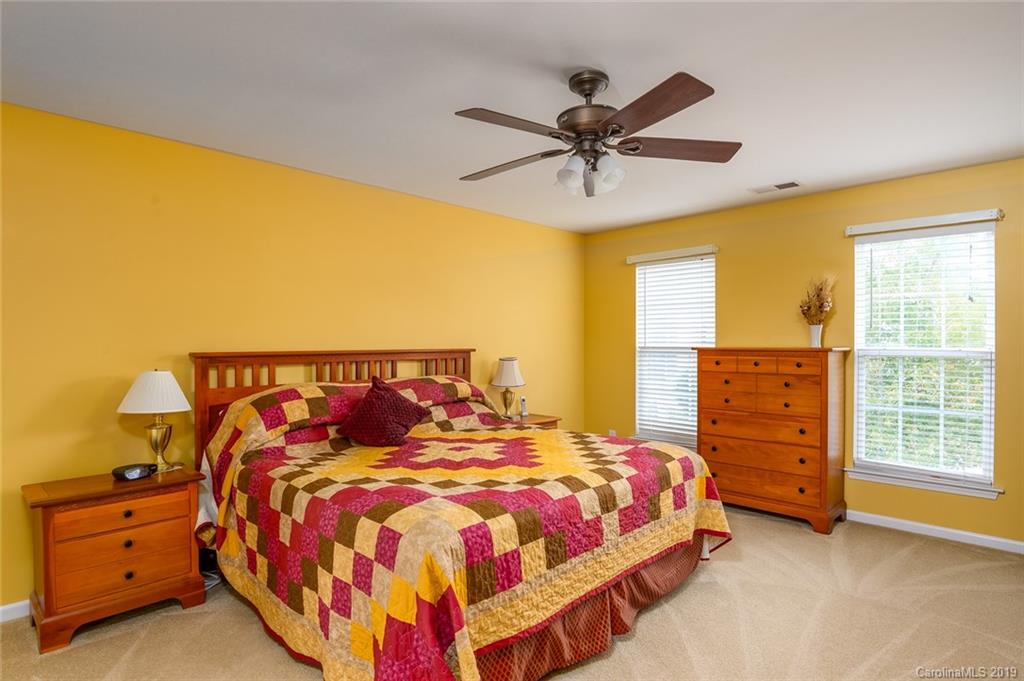 635 Eaton Court Fort Mill, SC 29708 - Photo 21 of 28 a bedroom with a bed and a chandelier