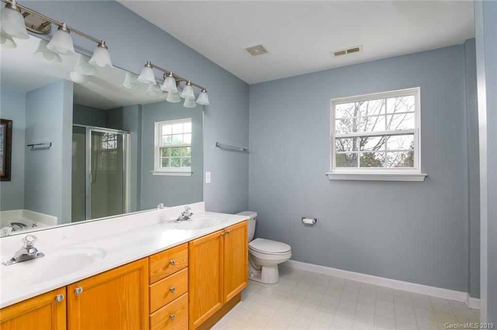 635 Eaton Court Fort Mill, SC 29708 - Photo 22 of 28 a spacious bathroom with a double vanity sink toilet mirror and bathtub