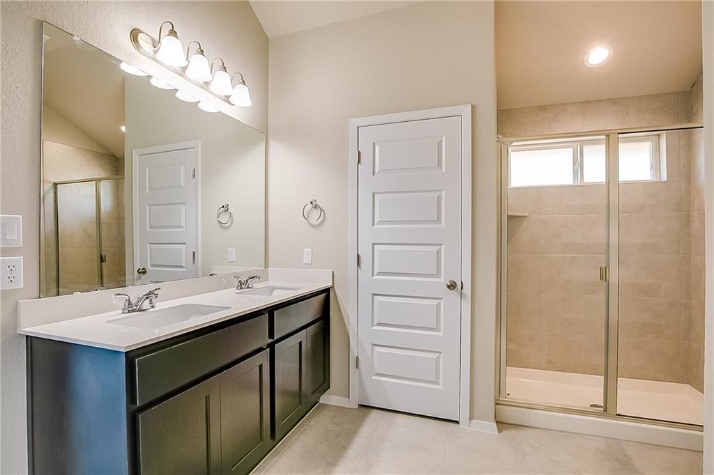 306 Delta Crest Maxwell, TX 78656 - Photo 16 of 24 a bathroom with a double vanity sink mirror and shower
