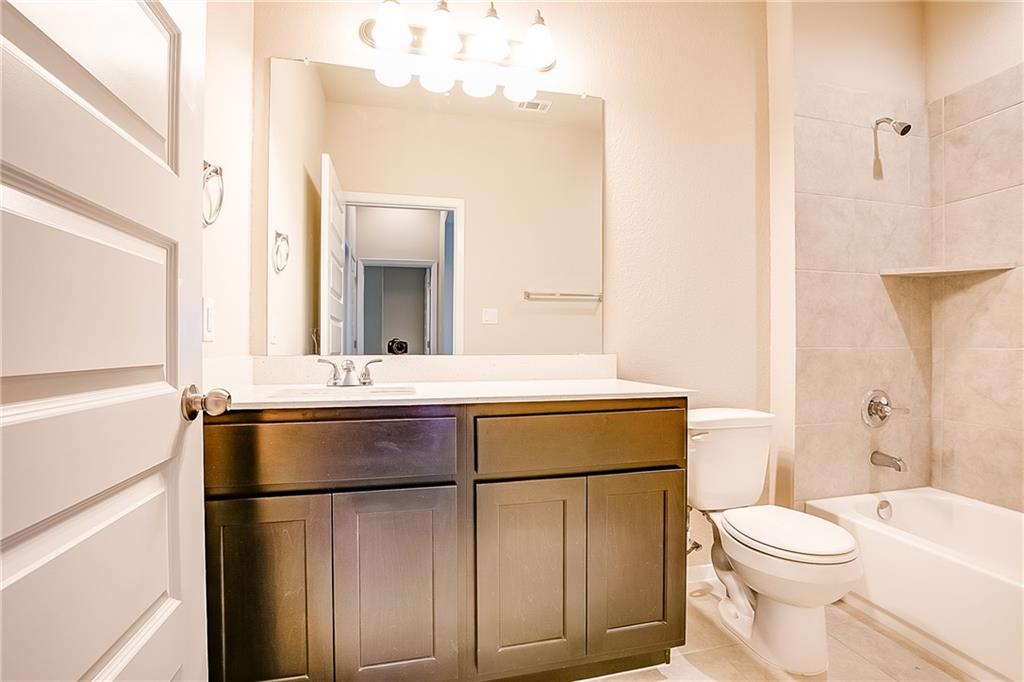 306 Delta Crest Maxwell, TX 78656 - Photo 19 of 24 a bathroom with a sink vanity mirror and toilet