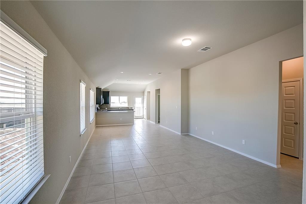 306 Delta Crest Maxwell, TX 78656 - Photo 5 of 24 a view of a refrigerator in kitchen and wooden floor