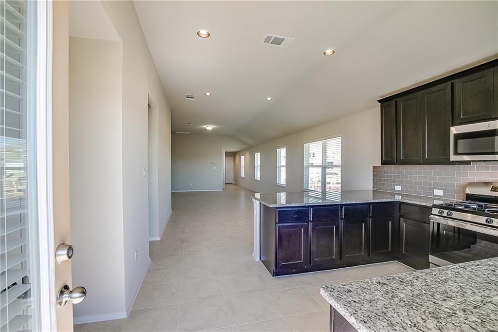 306 Delta Crest Maxwell, TX 78656 - Photo 24 of 24 a kitchen with stainless steel appliances granite countertop a stove and a sink