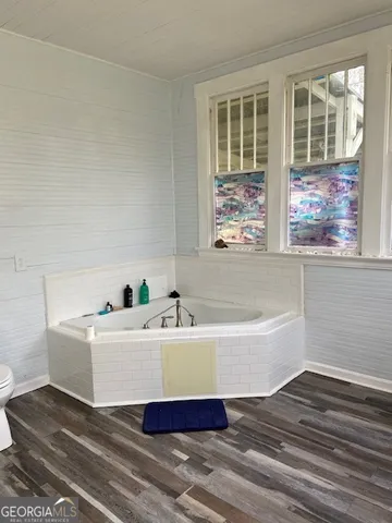 a bathroom with a bathtub and a window