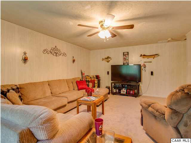 89 West Daffodil Road Ruckersville, VA 22968 - Photo 13 of 22 a living room with furniture and a flat screen tv
