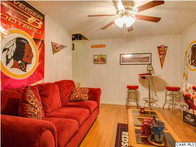 89 West Daffodil Road Ruckersville, VA 22968 - Photo 19 of 22 a living room with a couch and a chandelier