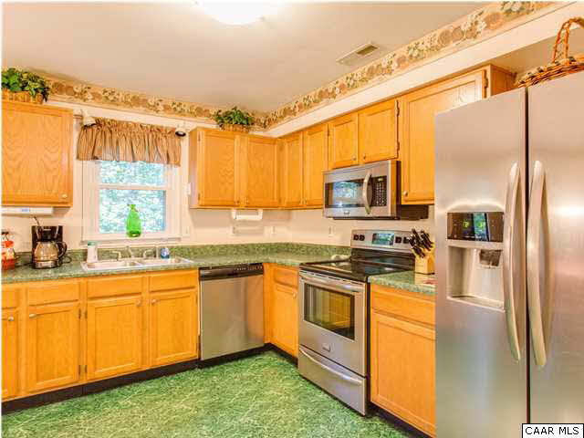 89 West Daffodil Road Ruckersville, VA 22968 - Photo 20 of 22 a kitchen with stainless steel appliances granite countertop a stove a sink and a refrigerator