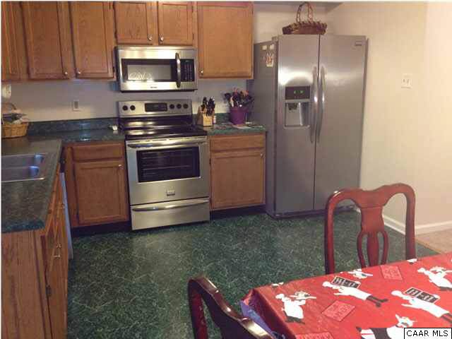 89 West Daffodil Road Ruckersville, VA 22968 - Photo 4 of 22 a kitchen with stainless steel appliances a stove a microwave and a cabinets
