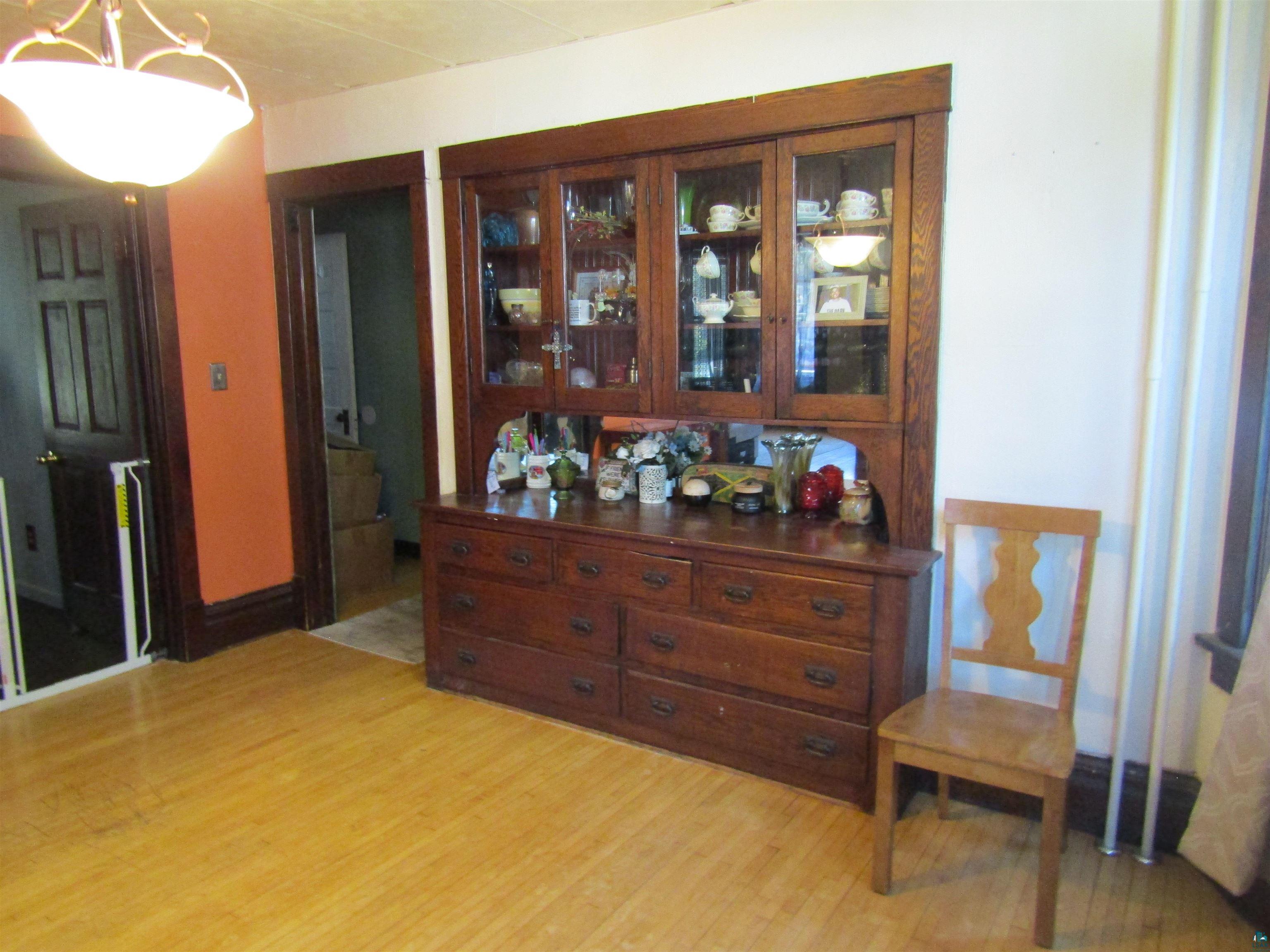1115 Harrison Street Superior, WI 54880 - Photo 5 of 49 Built-in wooden cabinetry with glass-fronted upper cabinets and lower drawers