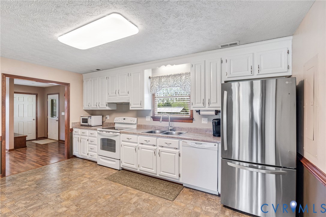 3411 Spring Run Road Mechanicsville, VA 23111 - Photo 20 of 41 a kitchen with white cabinets and white stainless steel appliances