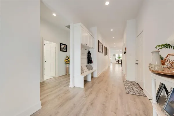 a dining room with furniture a chandelier and wooden floor