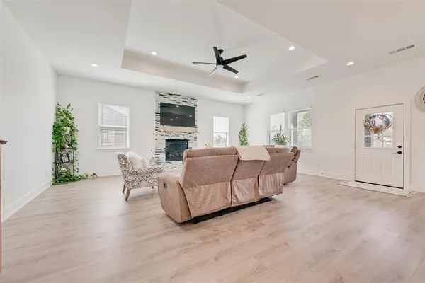 a kitchen with stainless steel appliances kitchen island granite countertop a dining table chairs and a refrigerator