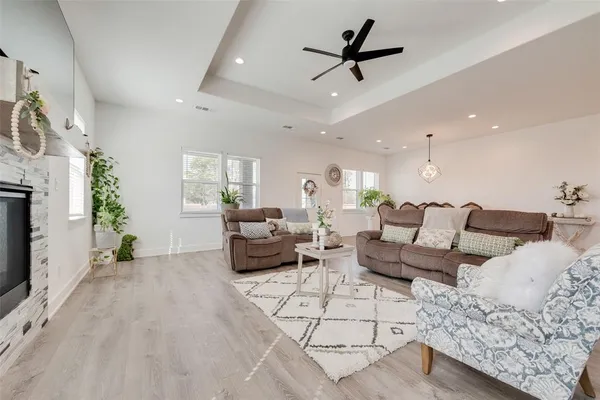 a large kitchen with stainless steel appliances granite countertop a lot of counter space and wooden floor