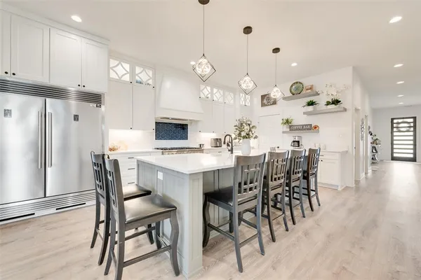 a bathroom with a tub shower and mirror