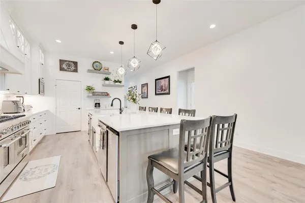 a kitchen with a sink cabinets and appliances