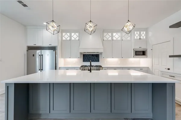 a kitchen with a stove a sink and a refrigerator