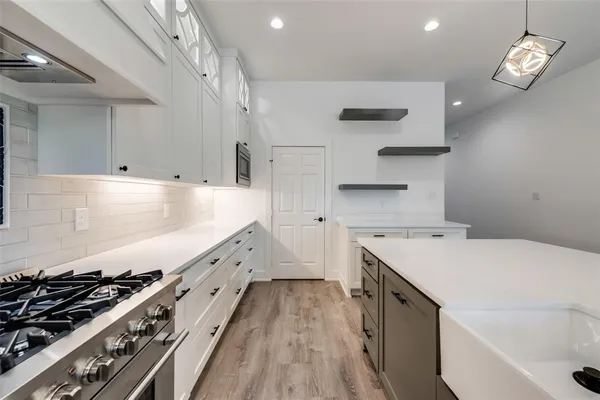 a kitchen with granite countertop a stove and a sink