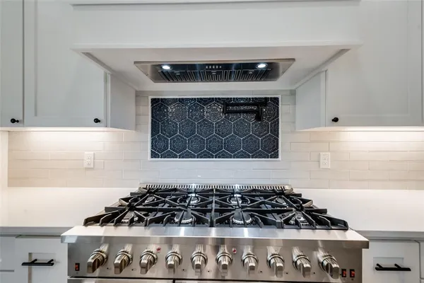 a kitchen with granite countertop white cabinets and window