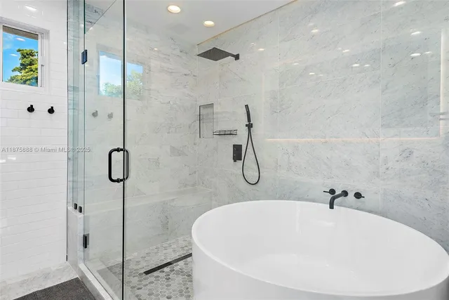 a bathroom with a white bath tub and shower